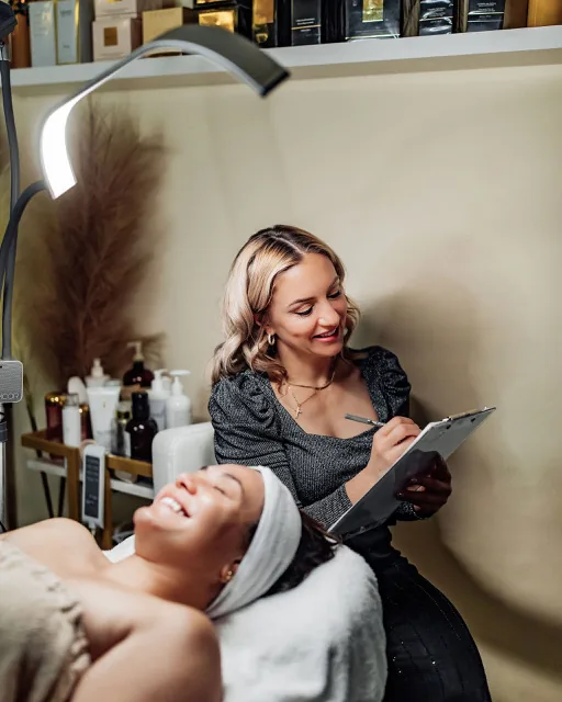Heather reviewing a personalized skincare plan with a facial client