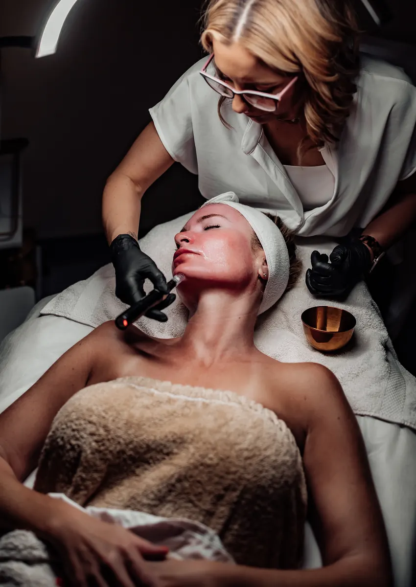 Heather using a professional microneedling device during a Tucson facial treatment