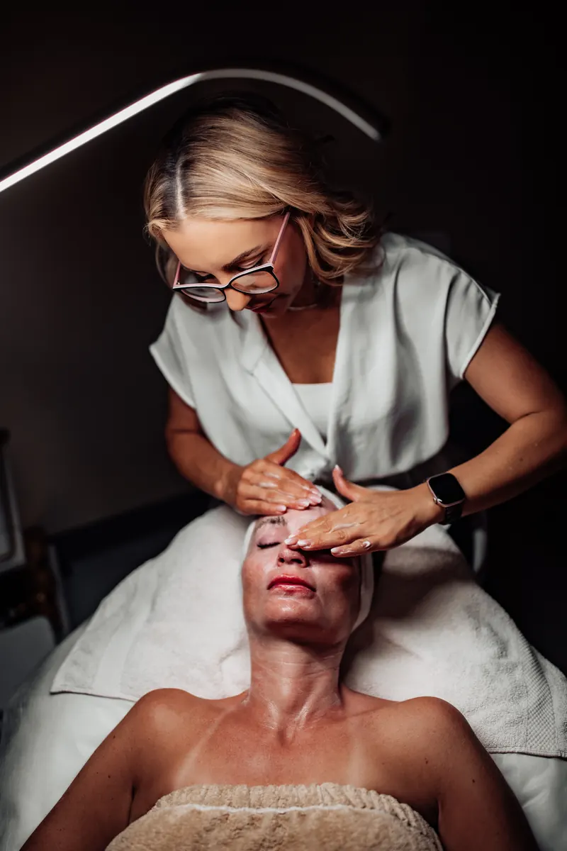 Heather preparing a client's skin before a microneedling appointment in Tucson